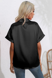 Black satin blouse with cuffed short sleeves and a button-down front, shown from the back.
