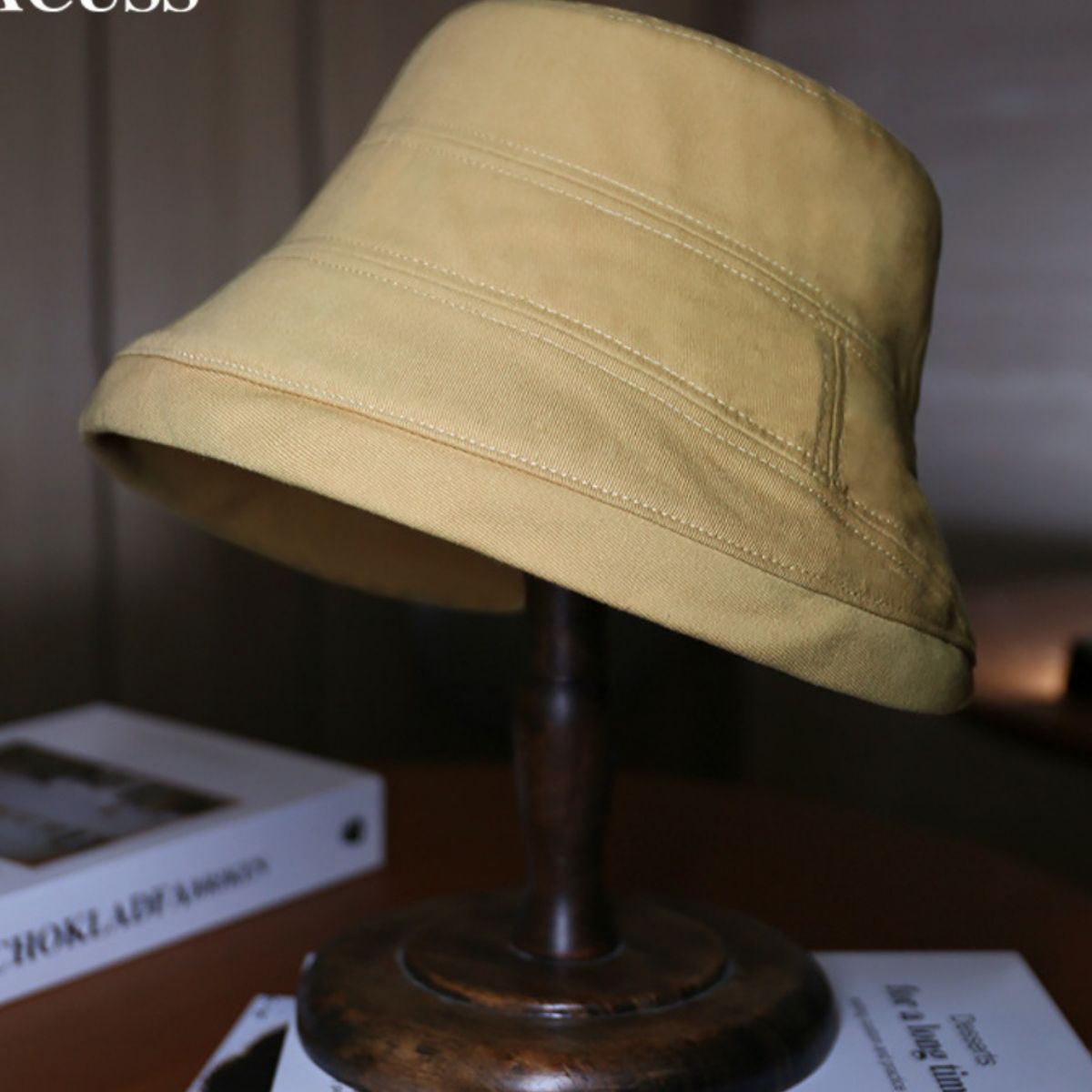 Cotton bucket hat in tan with stitched details for sun protection.