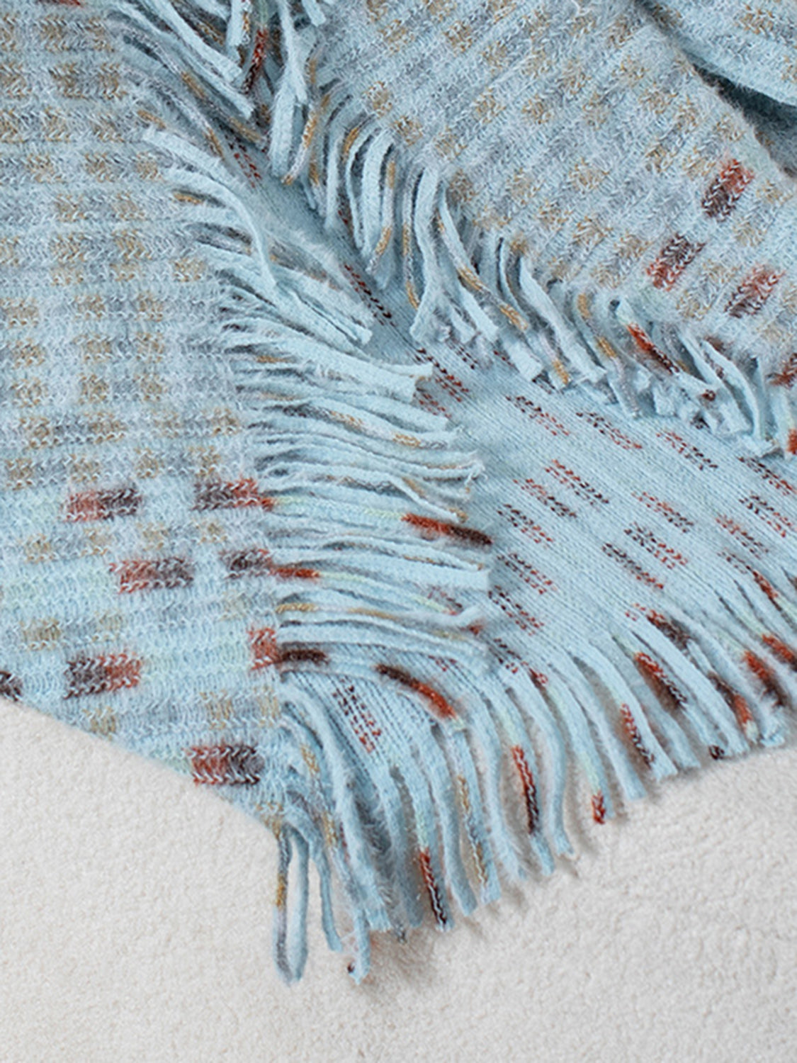 Light blue acrylic shawl cardigan with textured pattern and fringe details