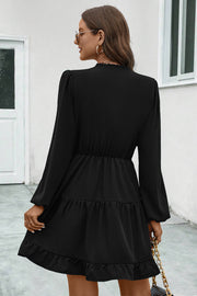 Black tiered ruffle sleeve mini dress with elastic waist and ruffled hem.