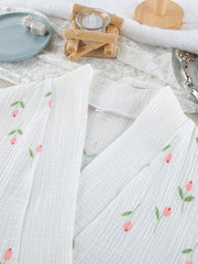 White cotton robe with delicate pink floral print and green leaves