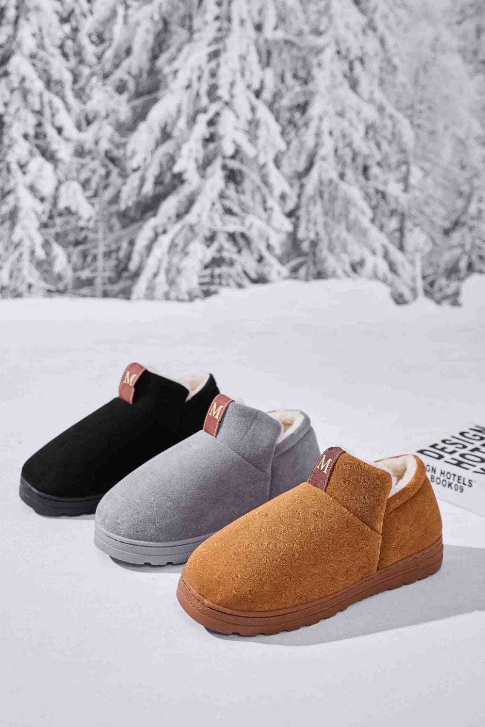 Suede shearling-lined house booties in caramel, gray, and black with pull tabs.