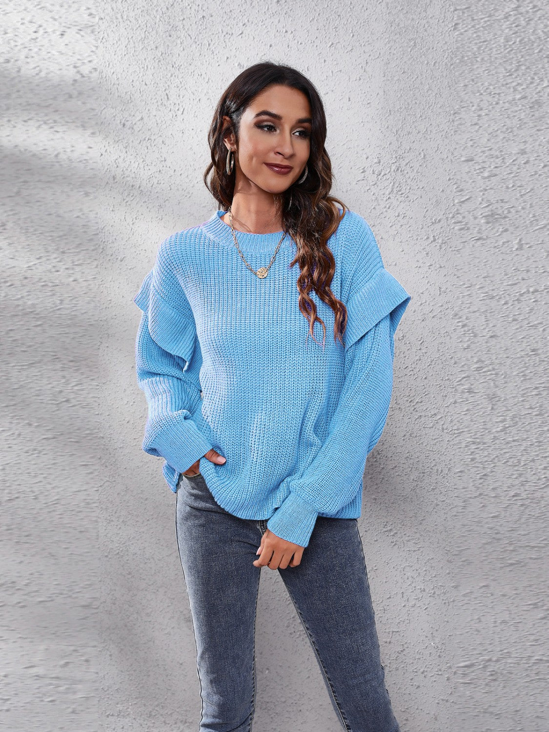 Pastel blue ribbed knit pullover sweater with ruffled sleeves and crew neck.