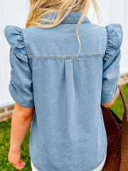 Light blue denim shirt with ruffled short sleeves and back pleats.