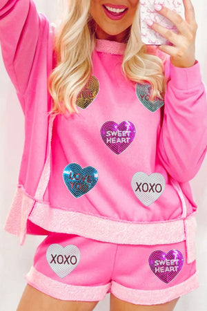 Pink loungewear set with heart sequin details and "Sweet Heart" and "XOXO" text.