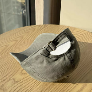 Distressed vintage cotton baseball hat in dark gray with adjustable strap and curved brim.