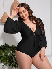 Black one-piece swimsuit with tie-front, deep V-neck, and ruched balloon sleeves.