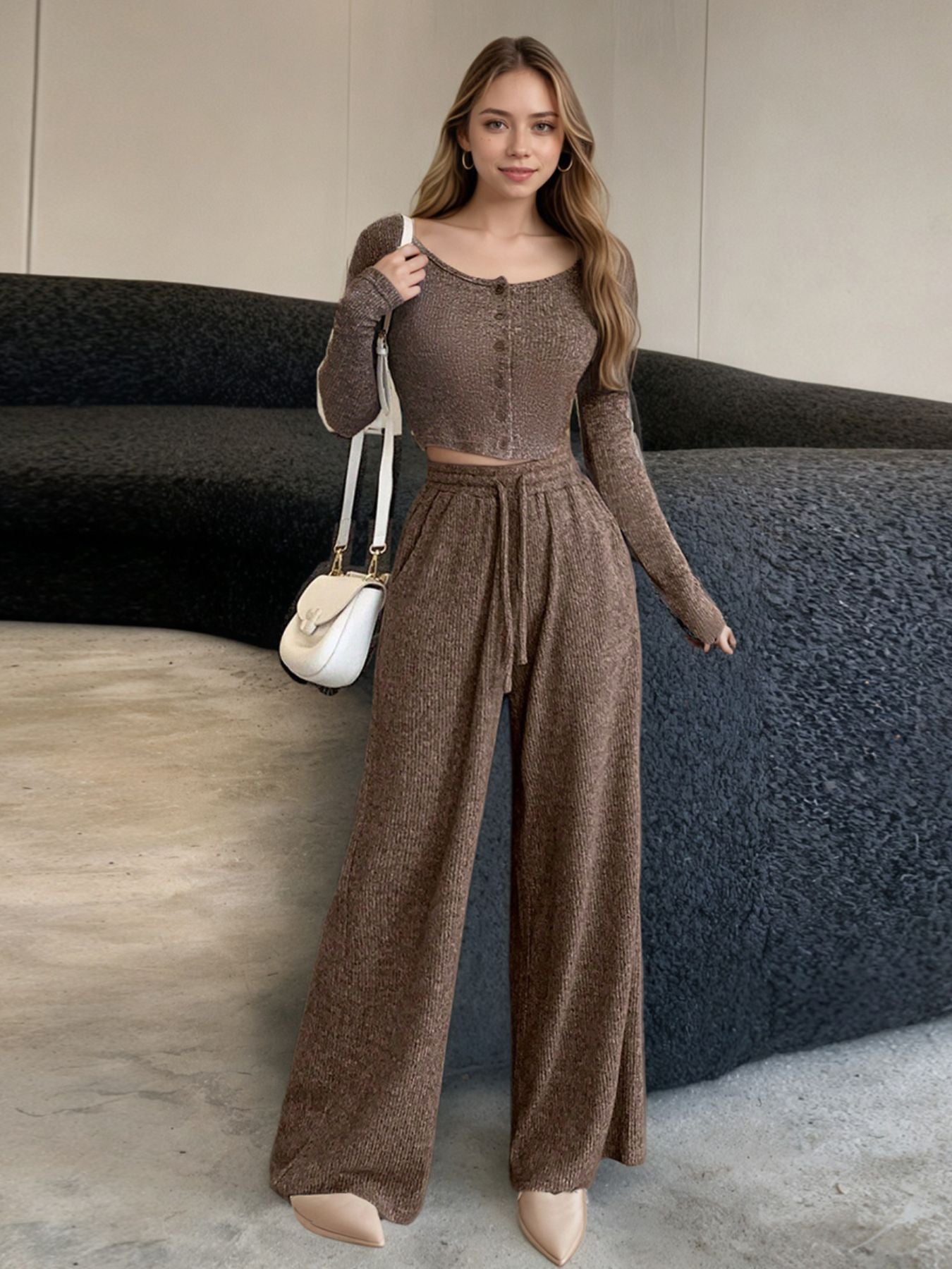 Brown ribbed knit two-piece loungewear set with button-down crop top and wide-leg pants.