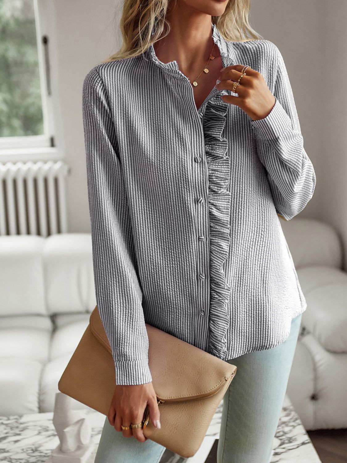 Striped ruffle-trimmed blouse with button front and stand collar.