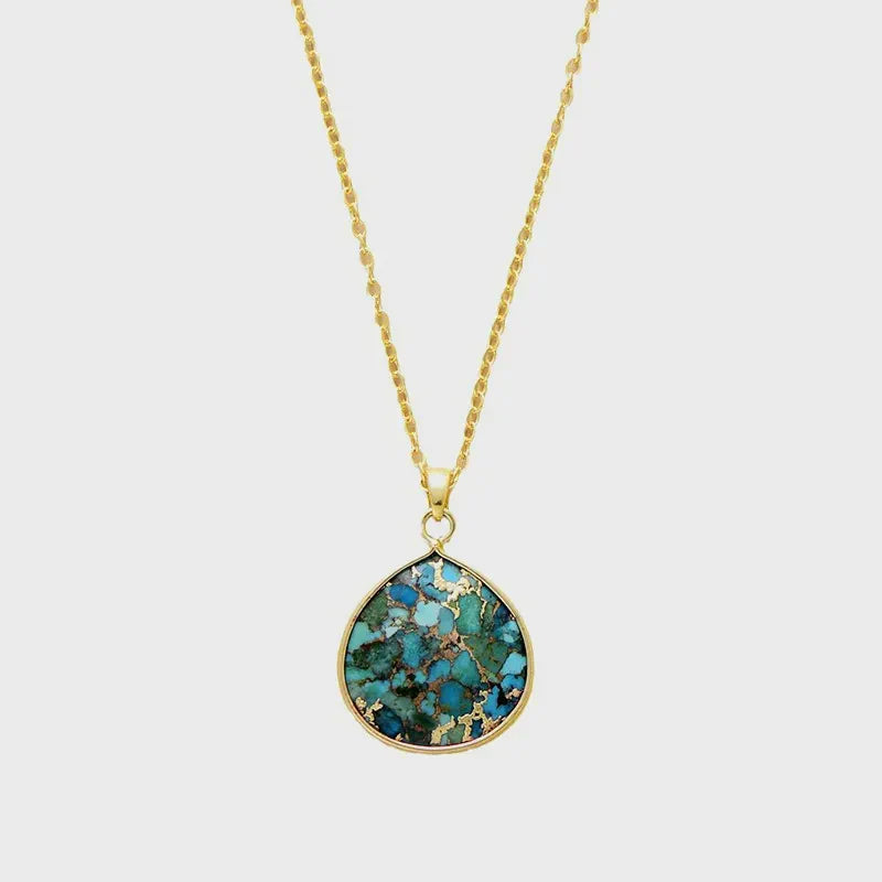 Gold chain necklace with a teardrop turquoise stone pendant with gold flecks.