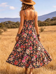 Black floral midi dress with spaghetti straps and tiered skirt.