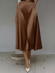 Elegant A-line satin skirt in dark brown with pockets, midi length.