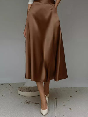 Elegant A-line satin skirt in dark brown with pockets, midi length.