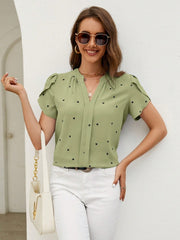 Matcha green blouse with black hearts, puff sleeves, and V-neck.