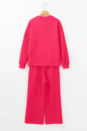 Textured weave lounge set in strawberry pink, featuring a crewneck sweatshirt and wide-leg pants.
