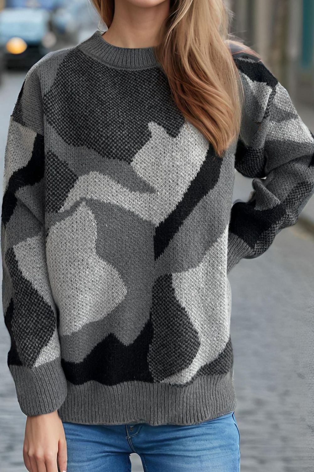 Geometric knit crewneck sweater in gray with colorblock pattern and ribbed trim.