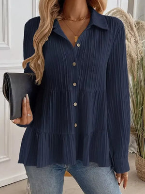 Dark blue textured tiered button-down shirt with crinkled fabric and button details.
