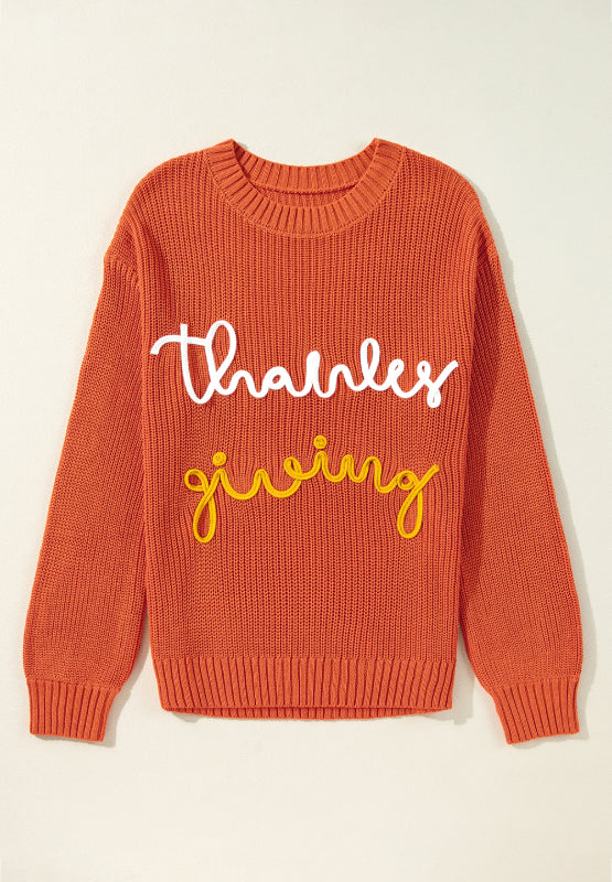 Orange knit sweater with white and yellow "thanks giving" text detail