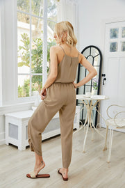 Gathered ankle cami jumpsuit in khaki with a cinched waist and spaghetti straps.