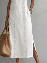 White sleeveless midi dress with geometric trim, pockets, and side slits.