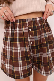 Brown plaid cotton shorts with elastic waist and button details.