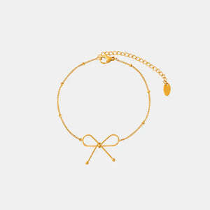 Gold delicate bow silhouette bracelet with beaded chain and adjustable clasp