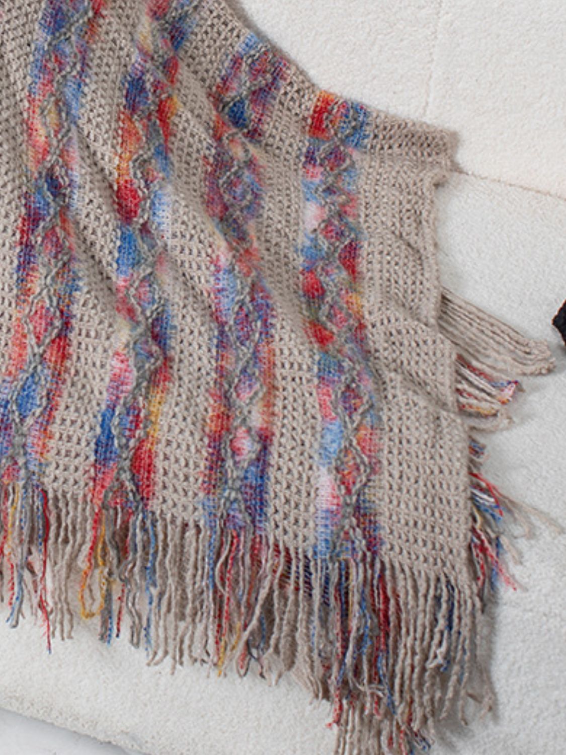 Textured knit cape in mocha with colorful diamond pattern and fringe detail