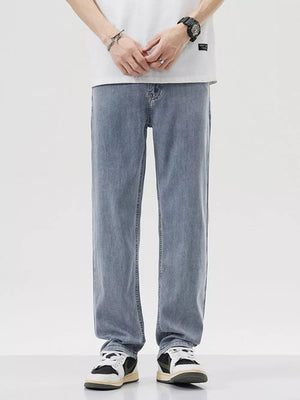 Relaxed fit wide-leg denim trousers in light blue, styled casually.