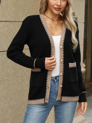 Black knit cardigan with contrast trim and gold buttons, featuring patch pockets.