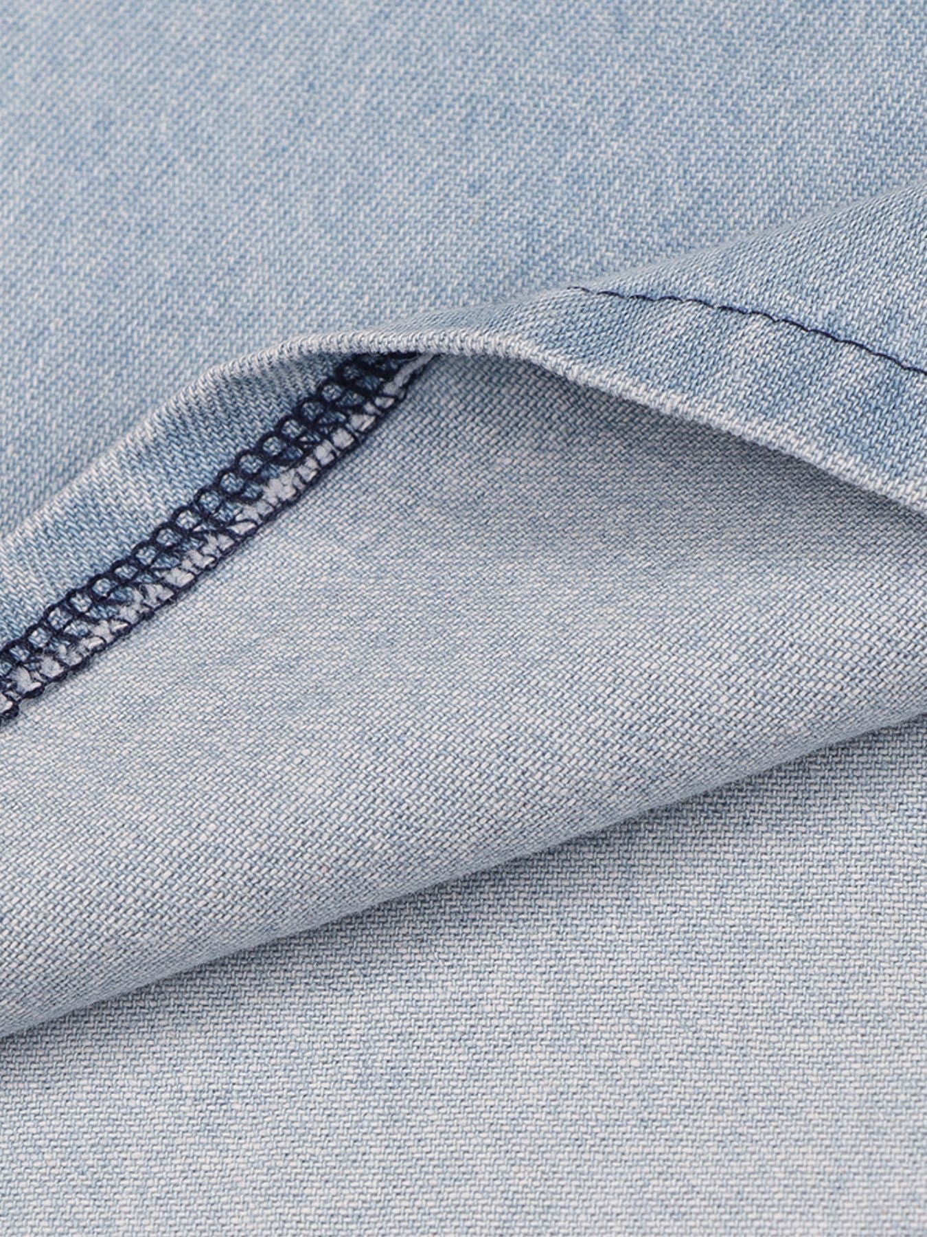Light wash denim mini dress fabric detail with visible stitching