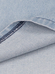 Light wash denim mini dress fabric detail with visible stitching