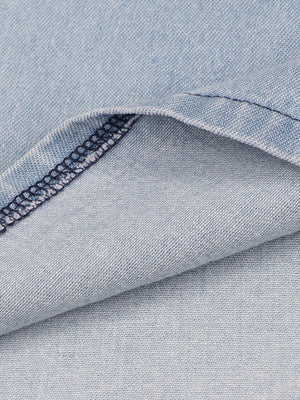 Light wash denim mini dress fabric detail with visible stitching