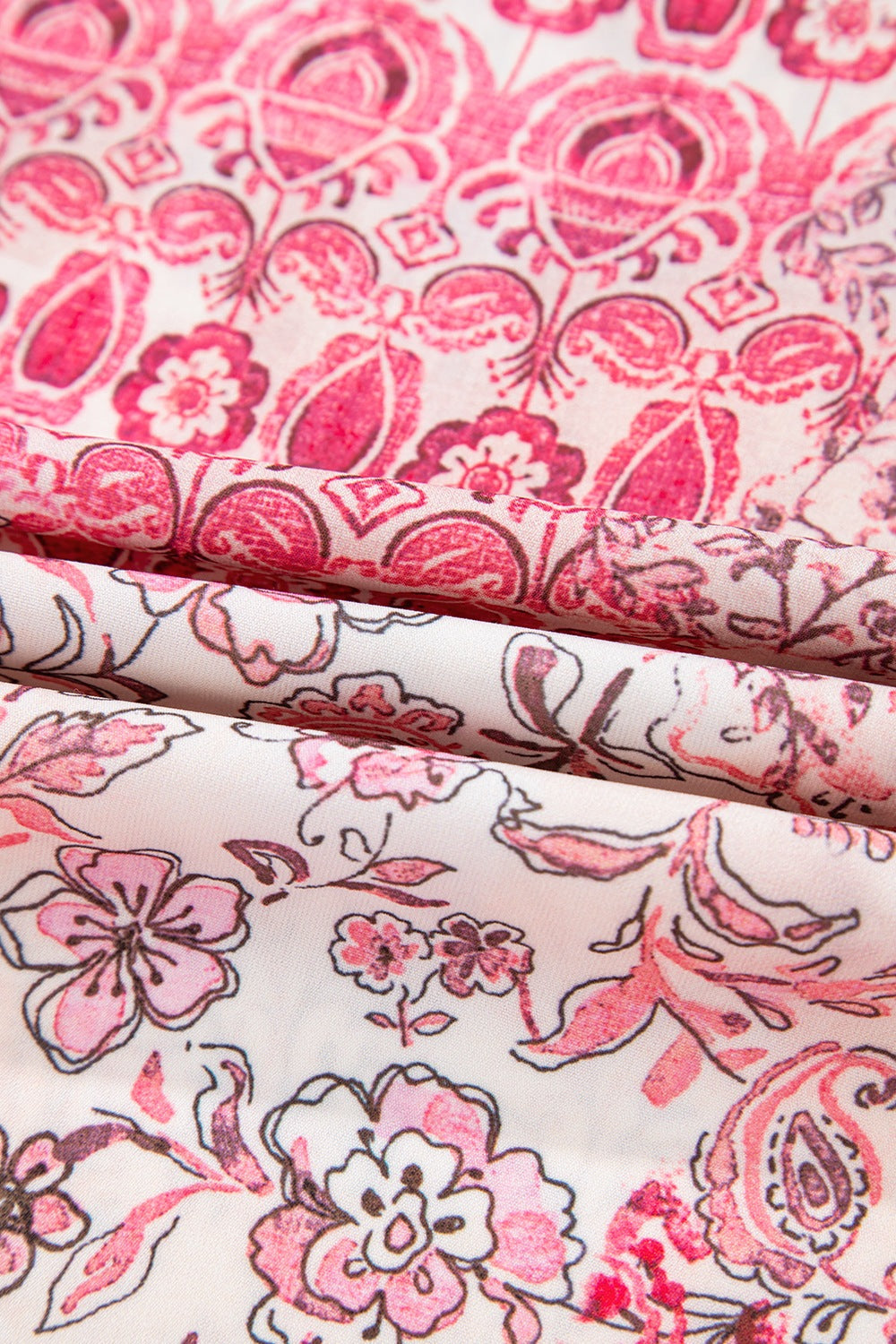 Tiered maxi skirt in dusty pink with a floral print and tassel detail.