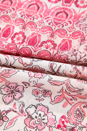 Tiered maxi skirt in dusty pink with a floral print and tassel detail.