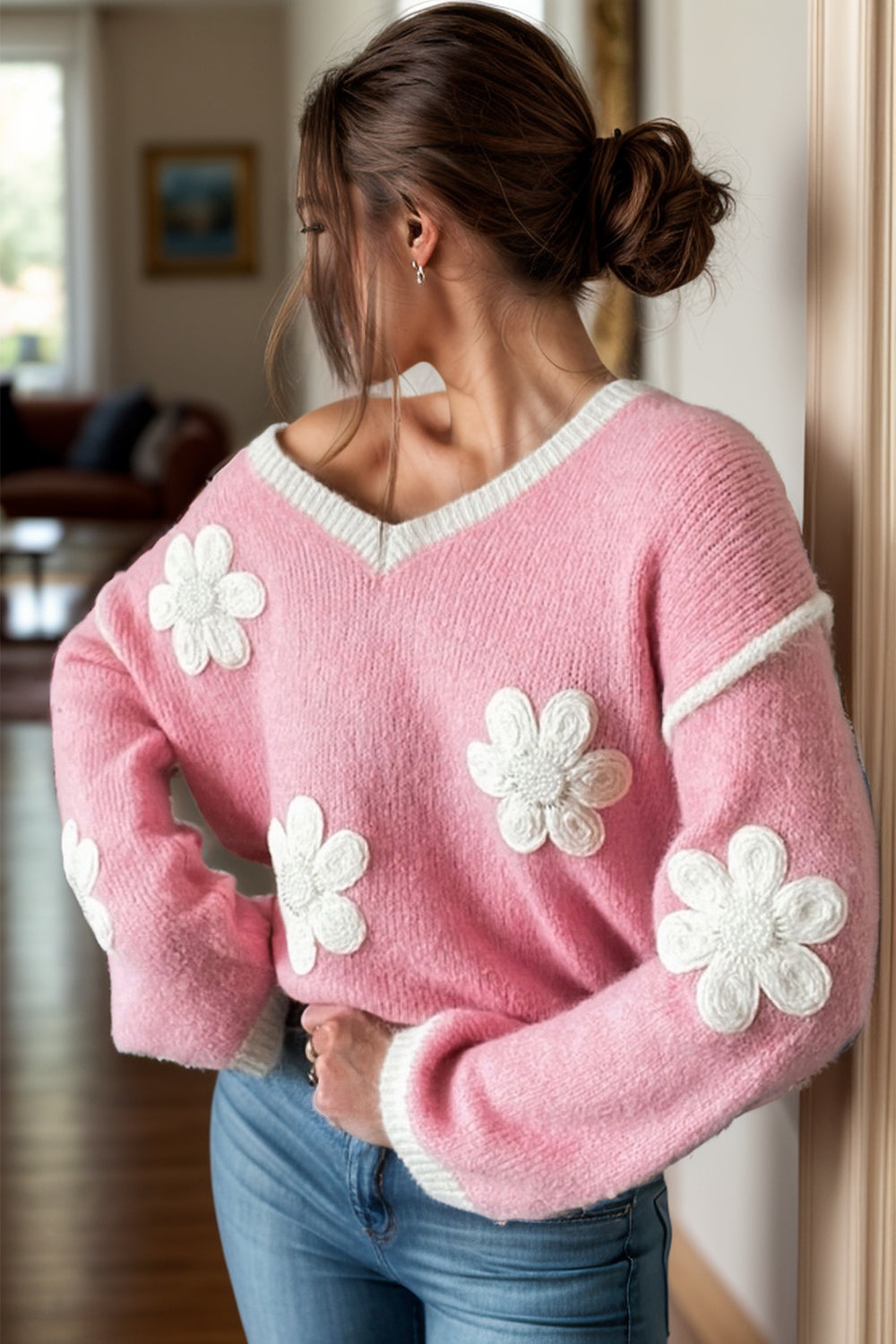Pink acrylic v-neck sweater with white daisy appliqués and contrast trim