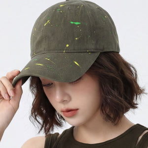 Sage cotton baseball cap with splatter paint detail.