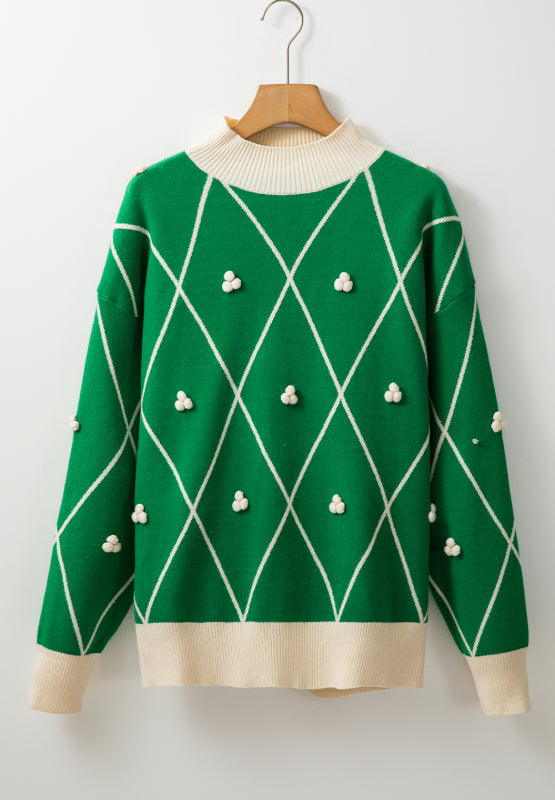Dark green argyle knit sweater with mock neck and pom-pom embellishments.