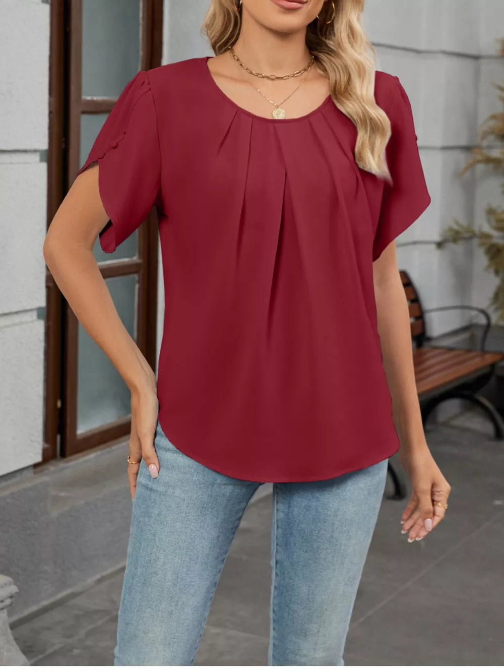 Wine red pleated short sleeve blouse with scalloped cuffs.