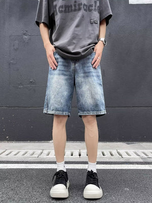 Blue relaxed fit denim shorts with a vintage wash and distressed details.