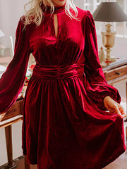 Burgundy velvet mock neck dress with keyhole cutout, balloon sleeves, and ruched waist detail.