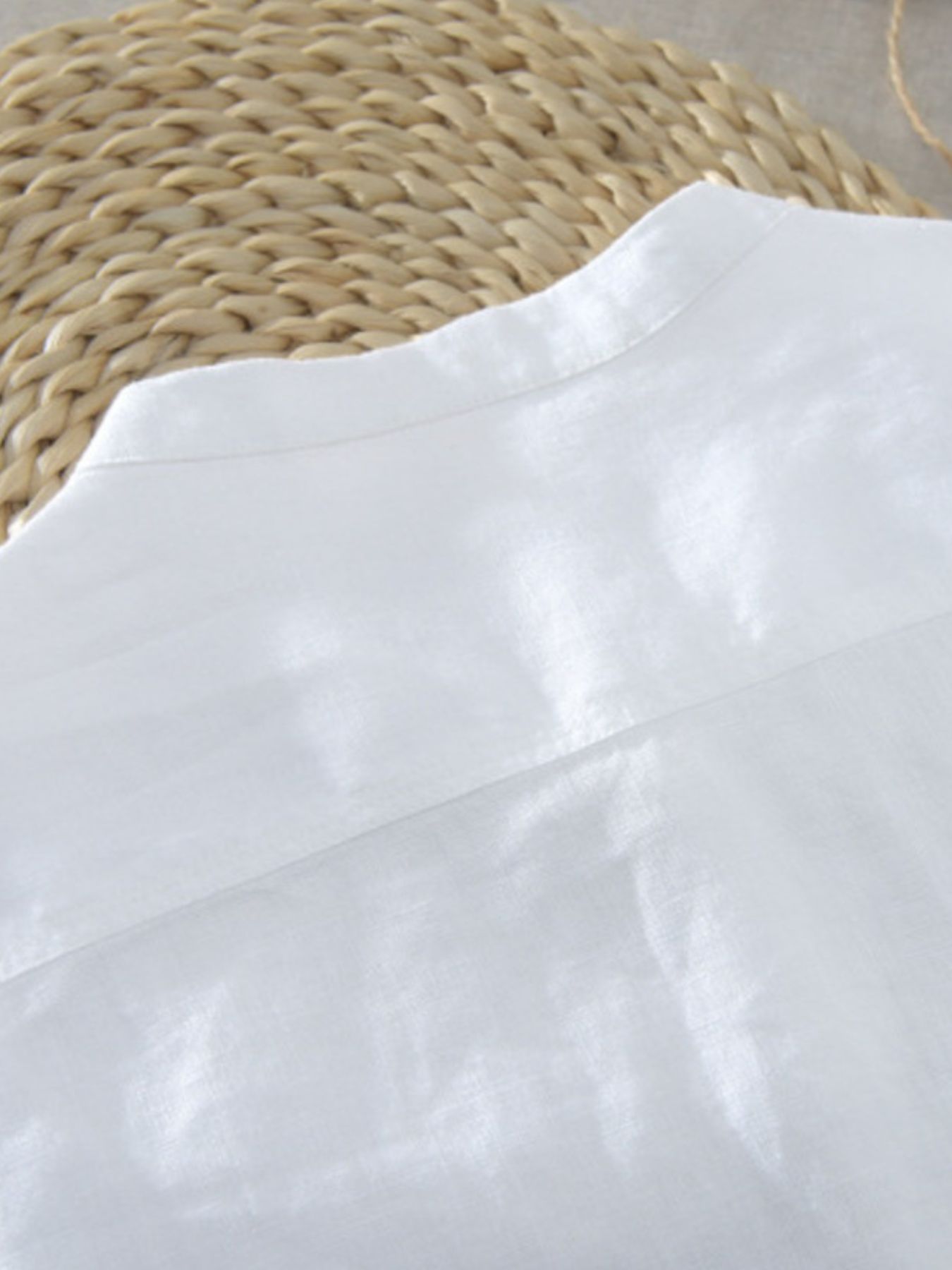 White cotton blend band collar shirt with button detail, close-up of collar and yoke.