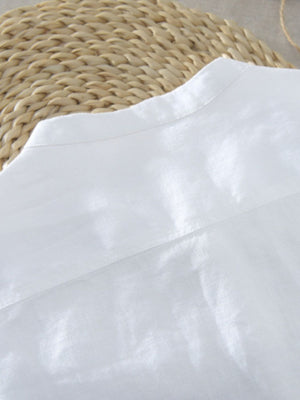 White cotton blend band collar shirt with button detail, close-up of collar and yoke.