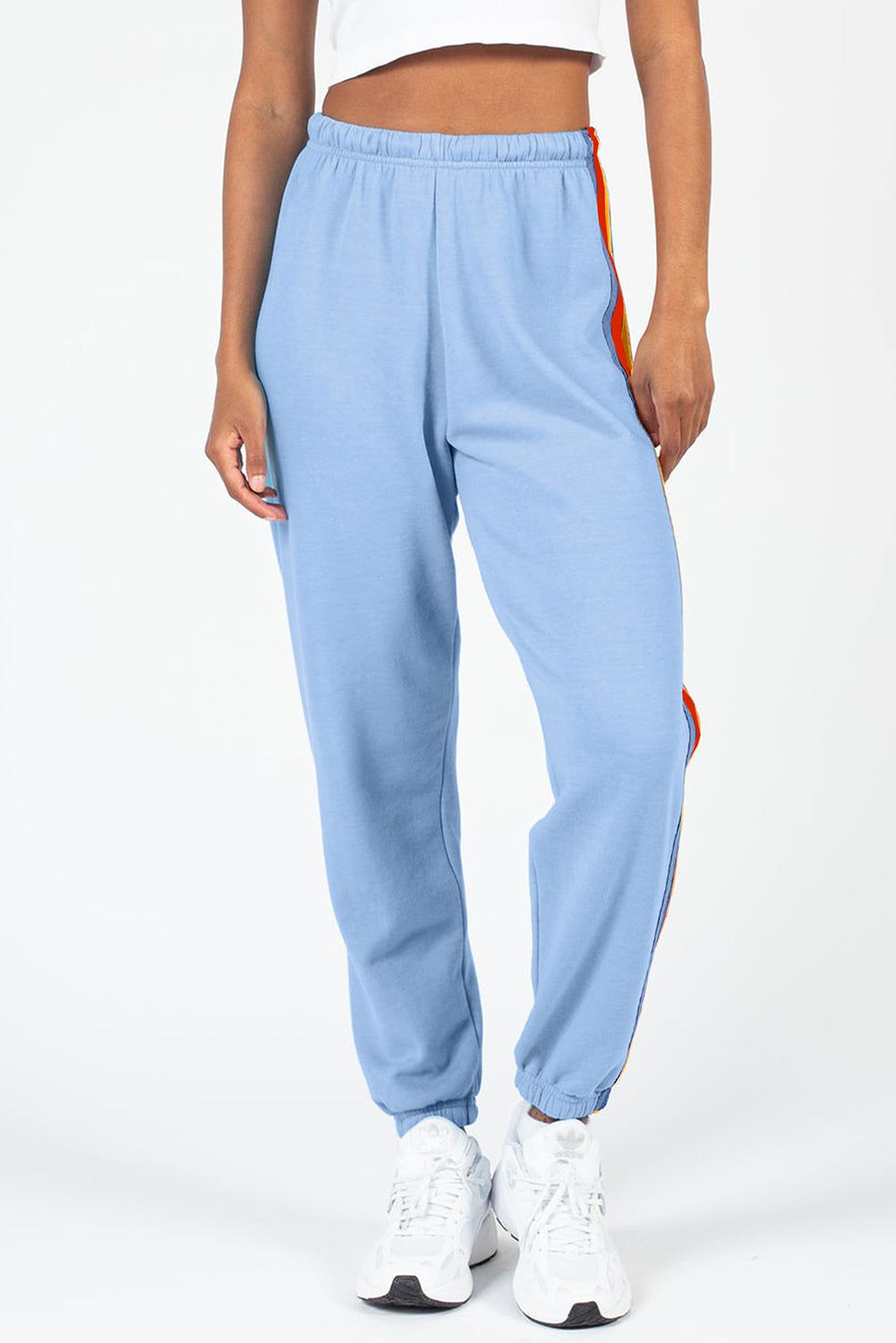 Light blue track pants with rainbow stripe detail down the side.