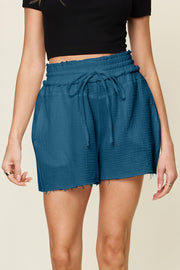 Dark blue textured gauze drawstring waist shorts with frayed hem