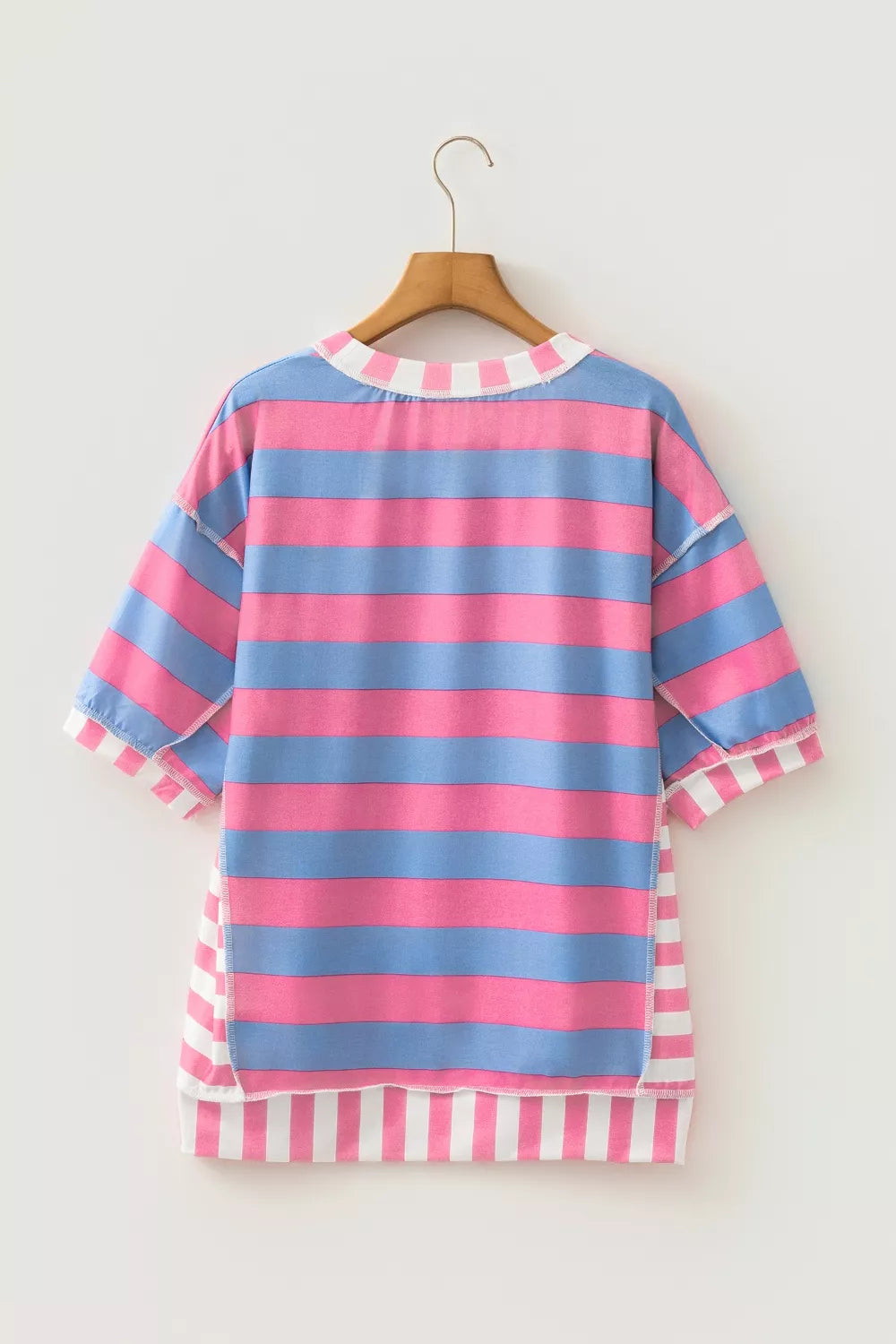 Oversized maternity shirt with pink and blue stripes, patchwork details, and white striped trim.