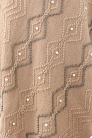 Khaki knit poncho with geometric pattern and pearl embellishments