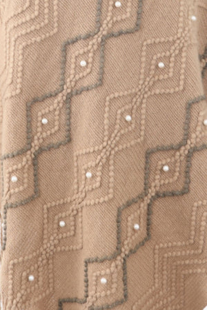 Khaki knit poncho with geometric pattern and pearl embellishments