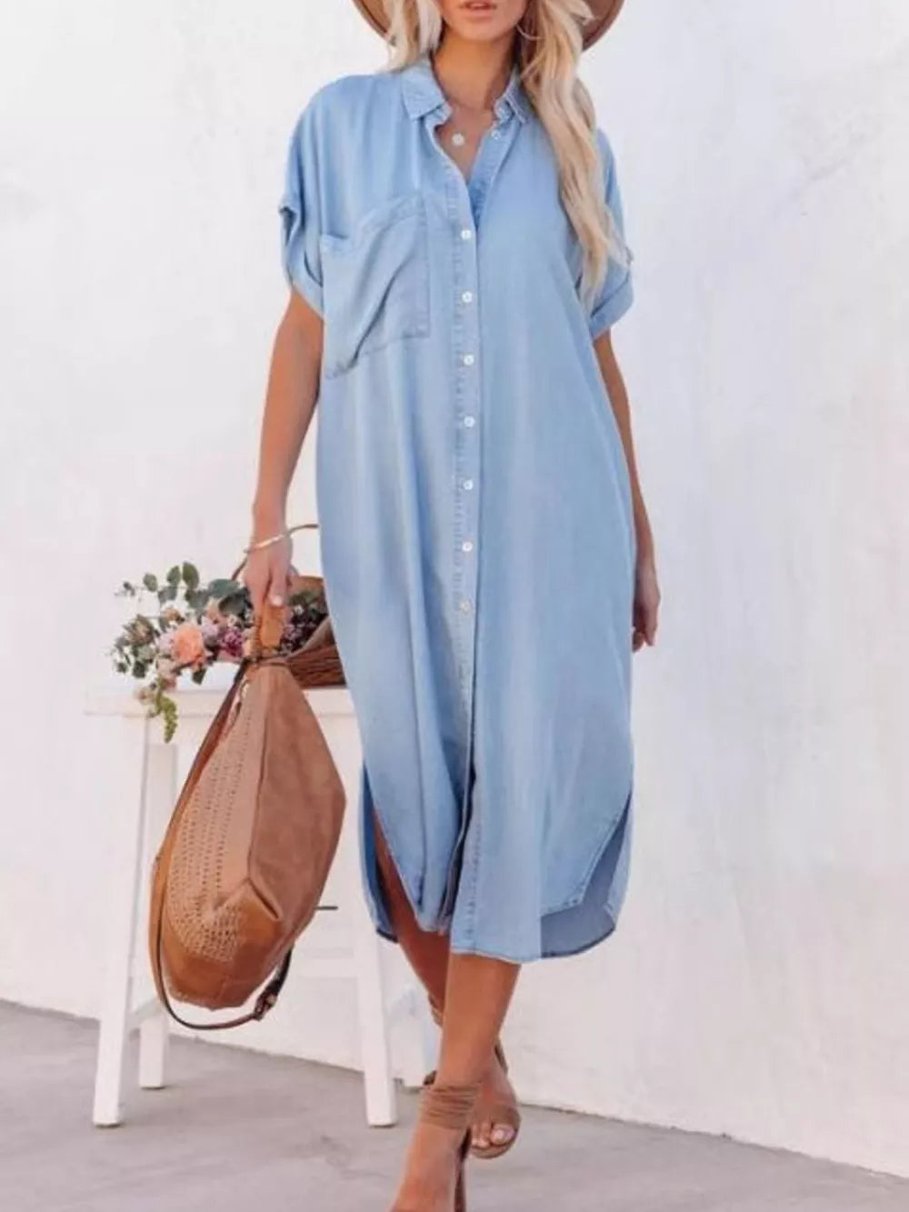Light blue denim midi shirt dress with short sleeves, button front, chest pockets and side slits.