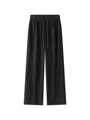 Men's black corduroy drawstring pants with a subtle textured pattern.