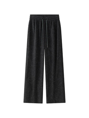 Men's black corduroy drawstring pants with a subtle textured pattern.